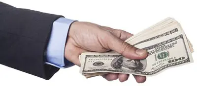 Hand Holding Dollars Hand in Suit Holding hundred dollar bills